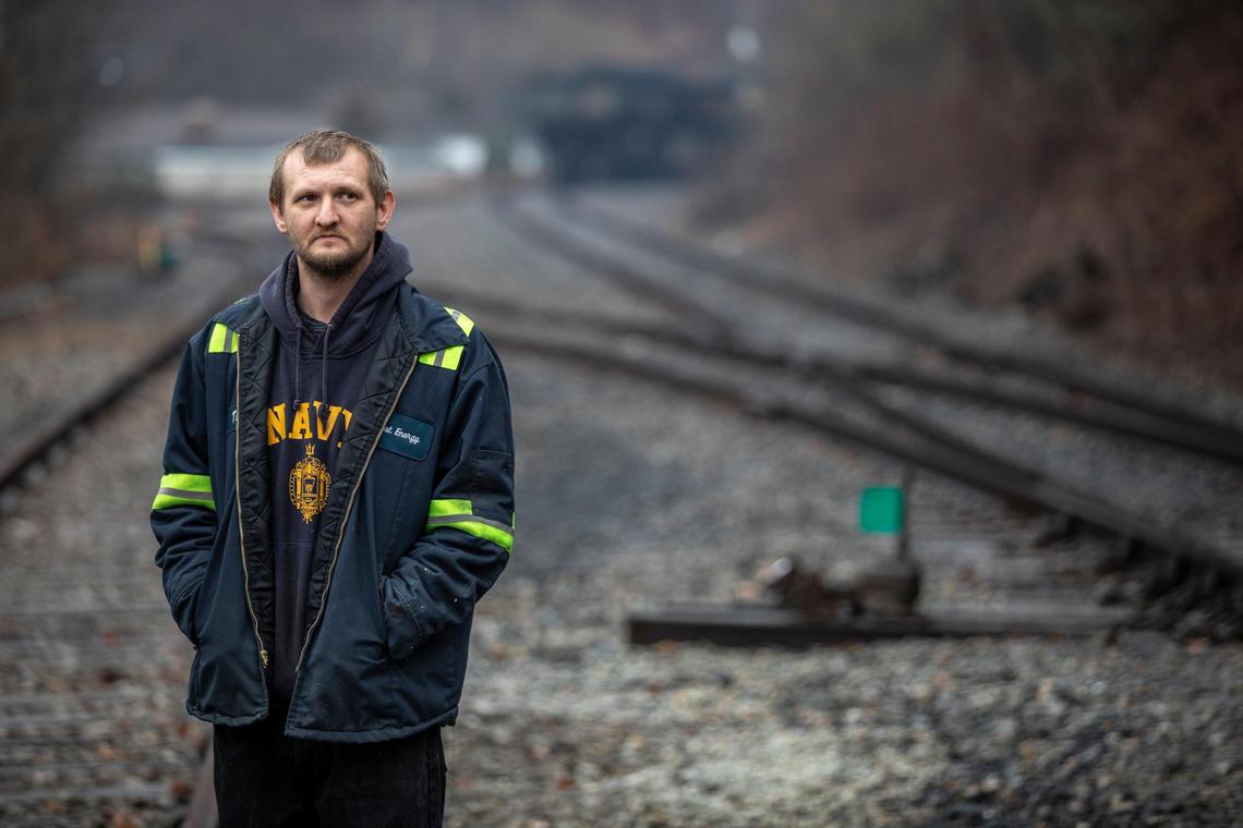 Timmy George, an employee of Quest Energy, stands on railroad tracks where miners, who say they haven’t been paid in three weeks, block a coal train in Pike County, Ky., Tuesday, Jan. 14, 2020.