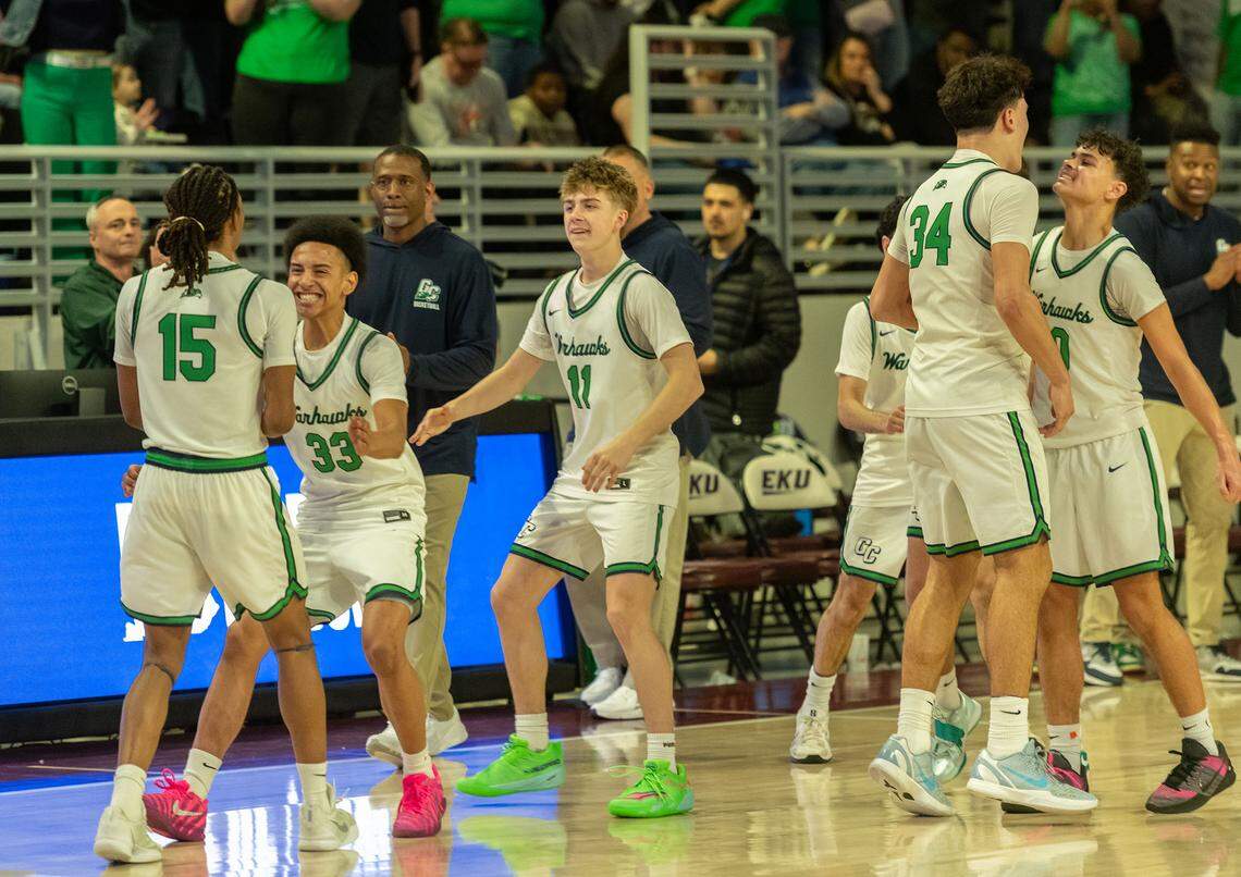 Great Crossing’s Jordan Koonce (15), Colmon Elridge (33), Colton Pensinger (11), Brady Orem (34) and Jesse Washington (10) celebrate their 50-42 win over Lexington Catholic in the boys 11th Region Tournament semifinals at Eastern Kentucky University’s Baptist Health Arena in Richmond on Saturday.
