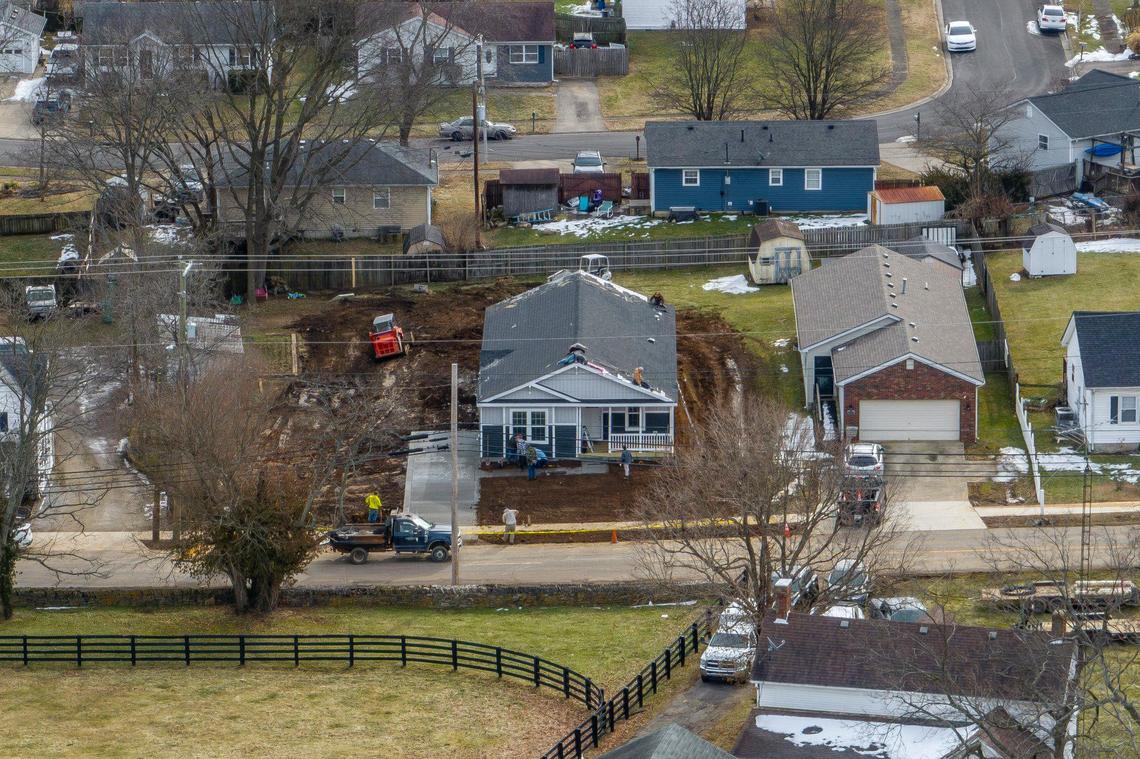 Workers install a manufactured home at 274 High Street in Versailles, Ky., Thursday, Jan. 30, 2025. The city of Versailles has a pilot project to install attractive manufactured homes into a residential neighborhood just outside downtown.