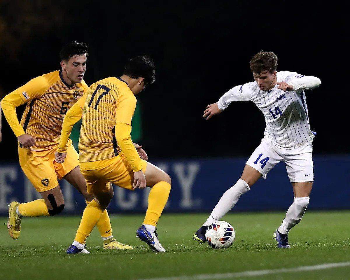 Kentucky’s Max Miller (14) evades pressure from West Virginia’s Yutaro Tsukada (17) and Dyon Dromers (6) during Wednesday night’s UK win.