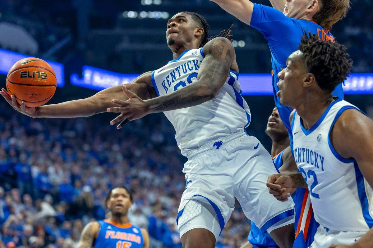 Kentucky guard Otega Oweh (00) shoots the ball as Florida forward Alex Condon (21) defends during Saturday’s game at Rupp Arena.