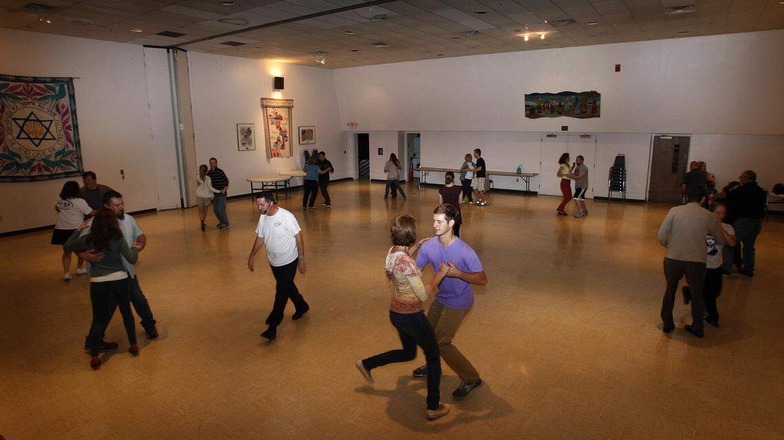 Bennett Skaggs and Olivia Cook dance during a beginners swing dance class conducted by the Hepcats dance group in the multipurpose room at Temple Adath Israel in Lexington, Ky., Monday, October 7, 2013. Photo by Matt Goins