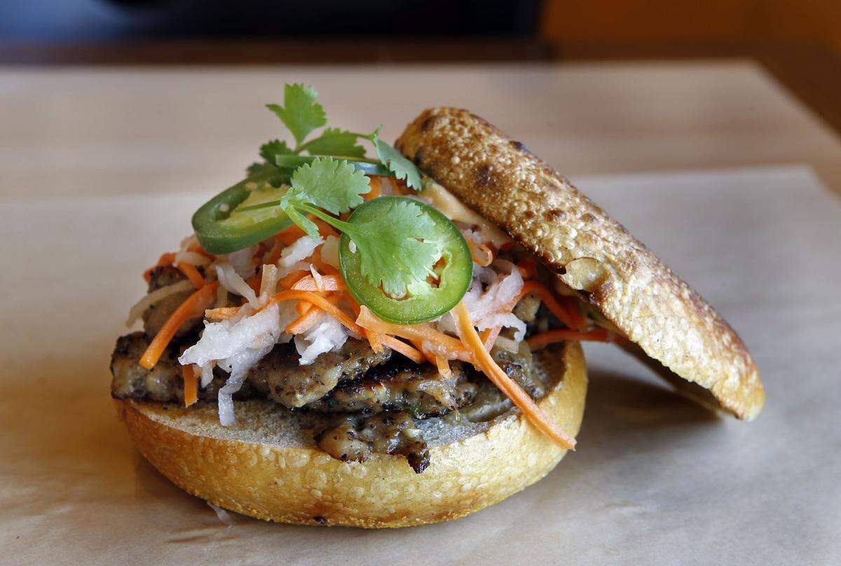 Great Bagel offers lunch items on their bagels like the BMB bagel sandwich, made with grilled pork meatballs, pickled carrots and daikon, sriracha mayo, jalapeno and cilantro on an egg bagel.