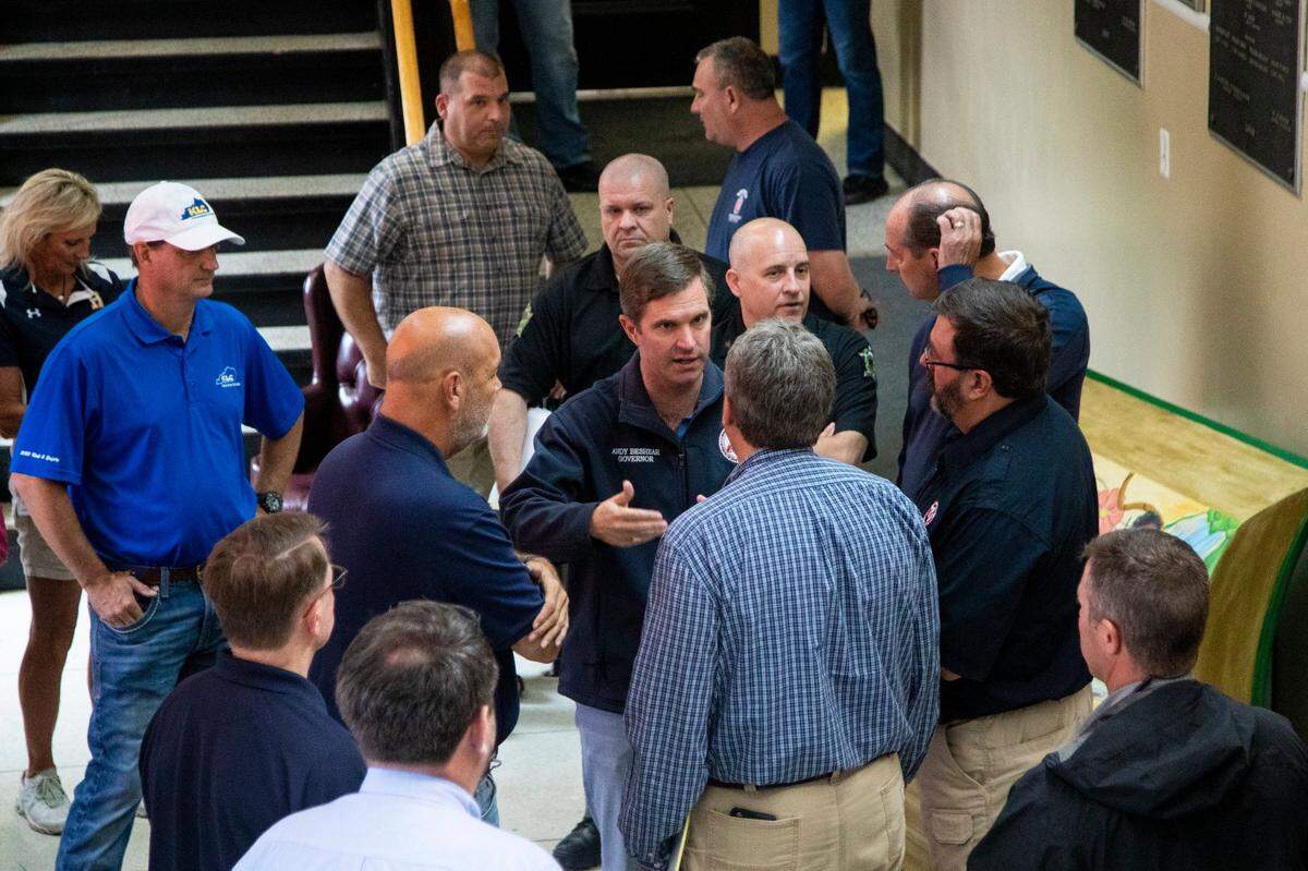 Gov. Andy Beshear speaks officials from Perry County and the City of Hazard before a press conference concerning the flooding in Eastern Kentucky at the Perry County Courthouse in Hazard, Ky., Sunday, July 31, 2022.