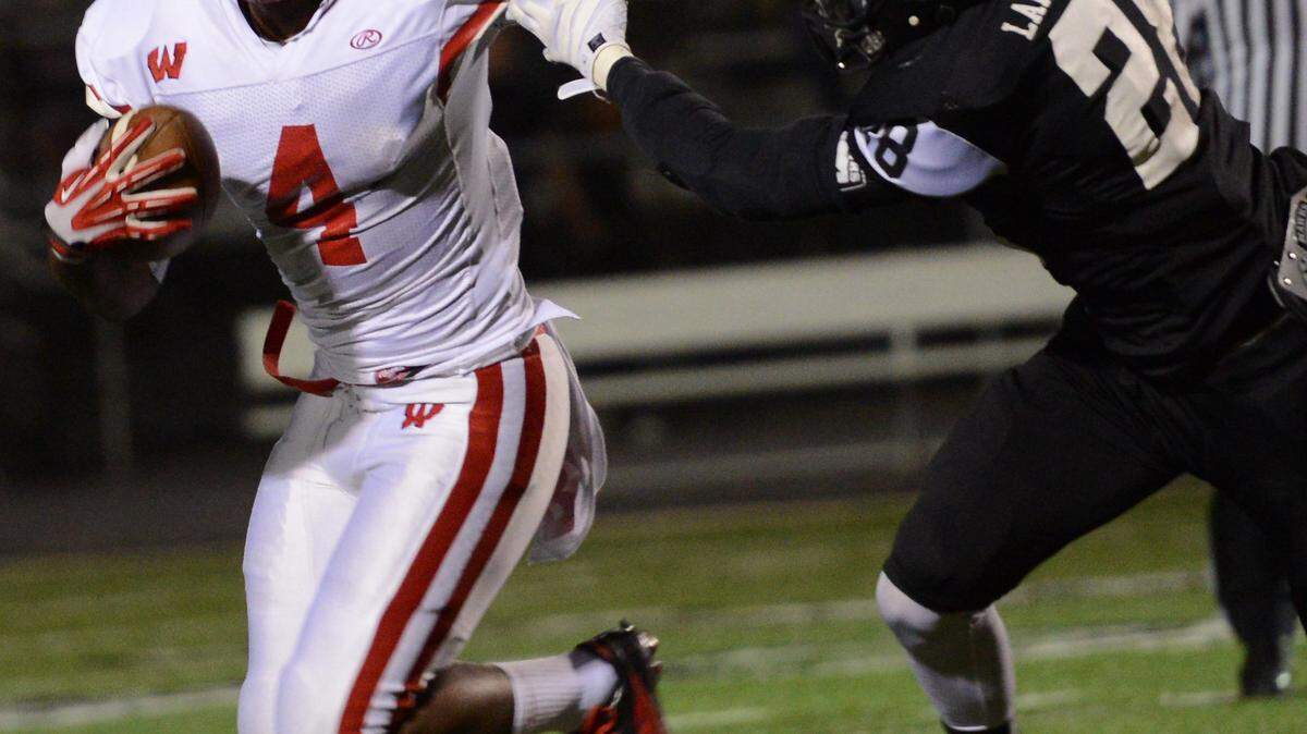 Lakota West running back Mikel Horton fought off a tackle by Lakota East's Justus Zamarron on Nov. 1, 2013, in West Chester, Ohio. Horton has signed to play for the University of Kentucky.