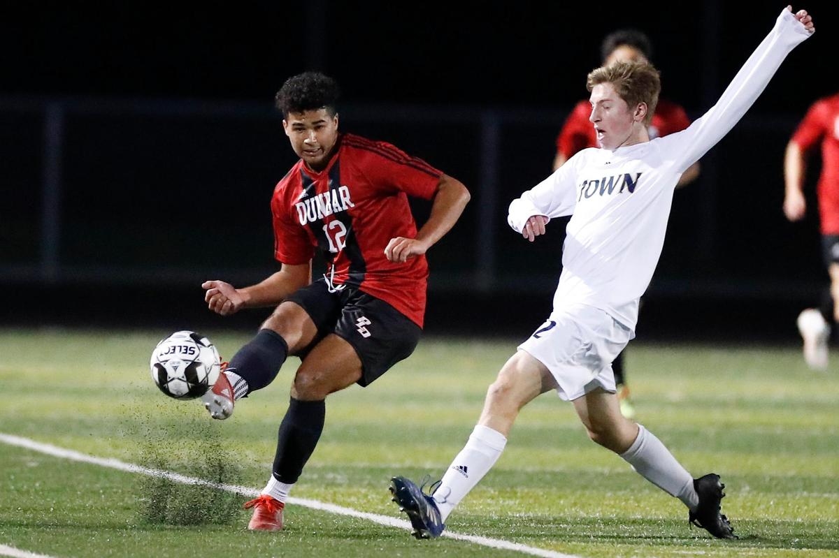 Paul Laurence Dunbar’s Antonio Blackman (12) gets past Elizabethtown’s Jonah Shirts (12) during Wednesday night’s semifinal match.