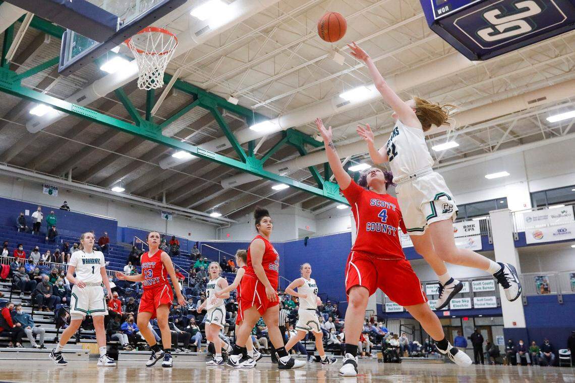 Great Crossing’s Ava Schureman (22) shoots over Scott County’s Kenady Tompkins (4).