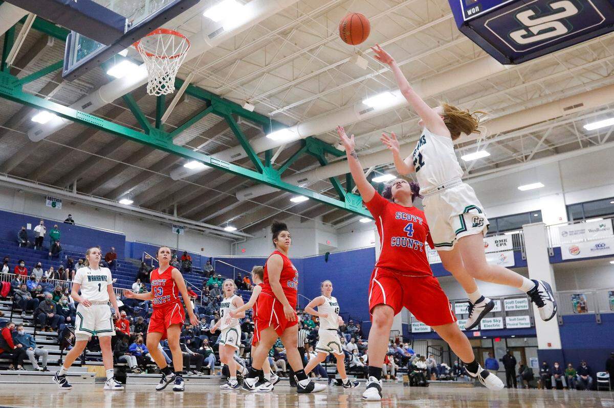 Great Crossing’s Ava Schureman (22) shoots over Scott County’s Kenady Tompkins (4).