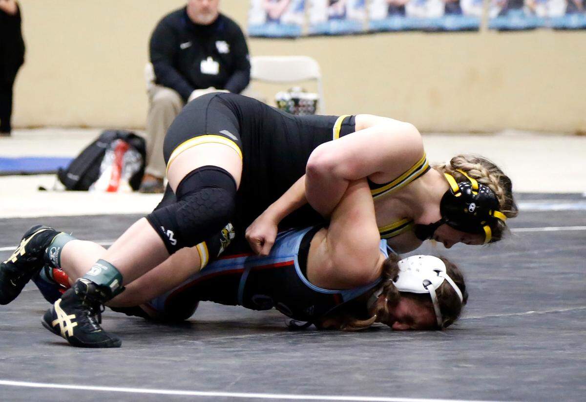 Woodford County’s Lauren Walton, top, tries to turn Union County’s Drew Sprague onto her back during their 132 finals match. Walton got the title-winning pin moments later.