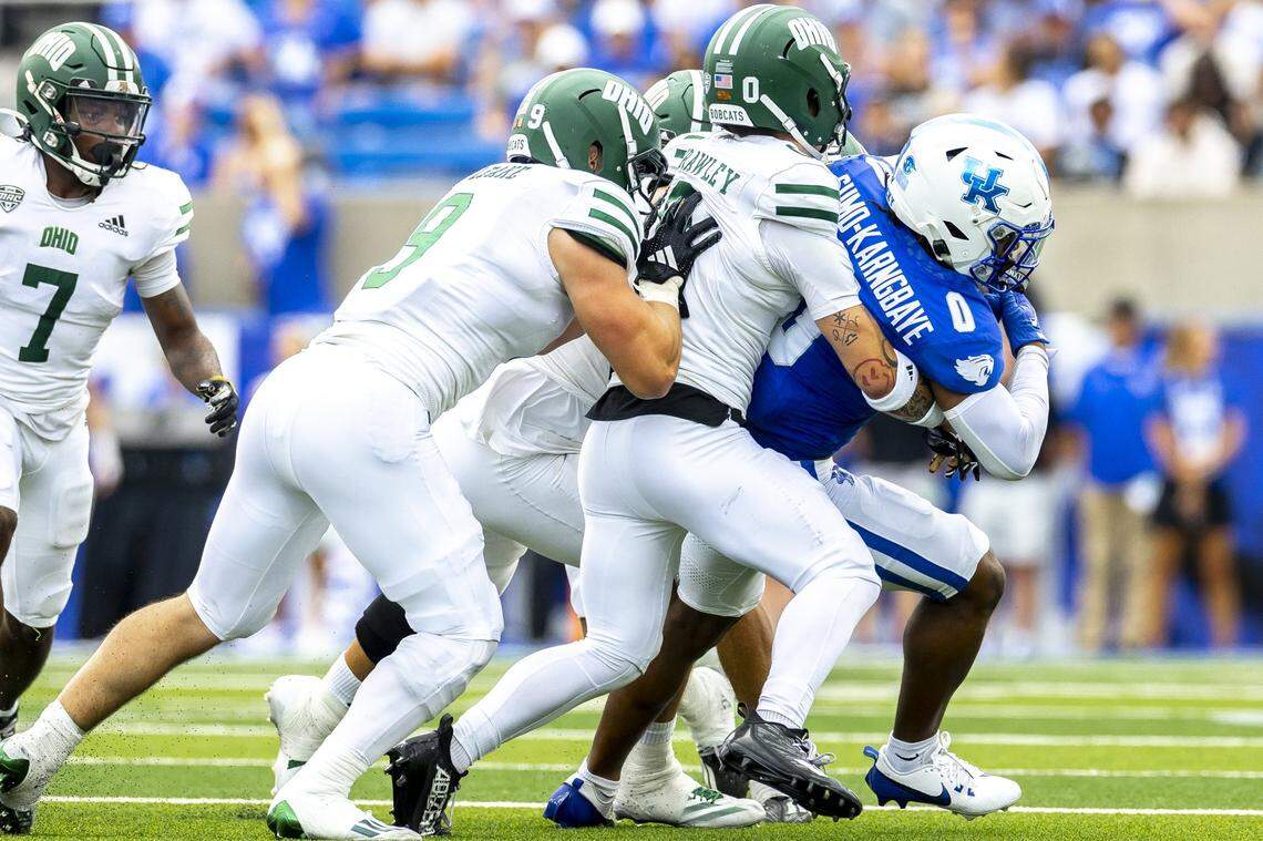 Kentucky running back Demie Sumo-Karngbaye (0) runs the ball as Ohio safety Austin Brawley (0) and linebacker Blake Leake (9) try to bring him down Saturday at Kroger Field. Sumo-Karngbaye carried 12 times for 47 yards and two touchdowns.