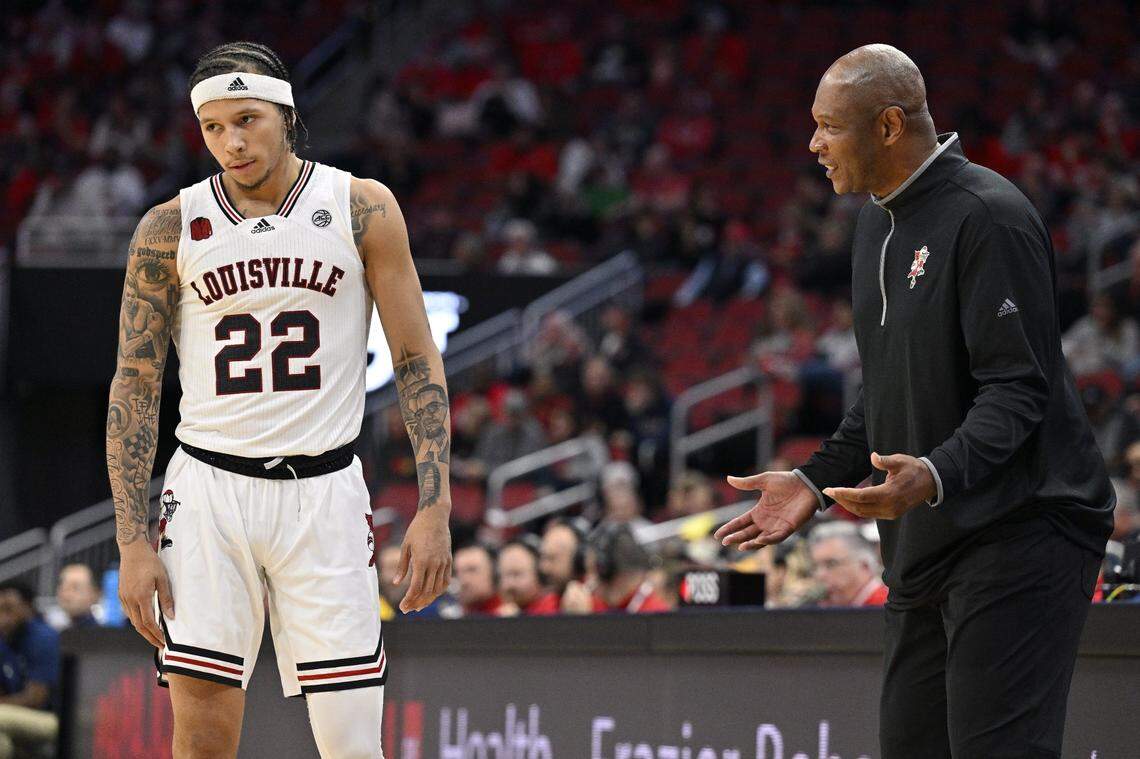 Nov 10, 2023; Louisville, Kentucky, USA; Louisville Cardinals head coach Kenny Payne talks with guard Tre White (22) during the second half against the Chattanooga Mocs at KFC Yum! Center. Chattanooga defeated Louisville 81-71. Mandatory Credit: Jamie Rhodes-USA TODAY Sports