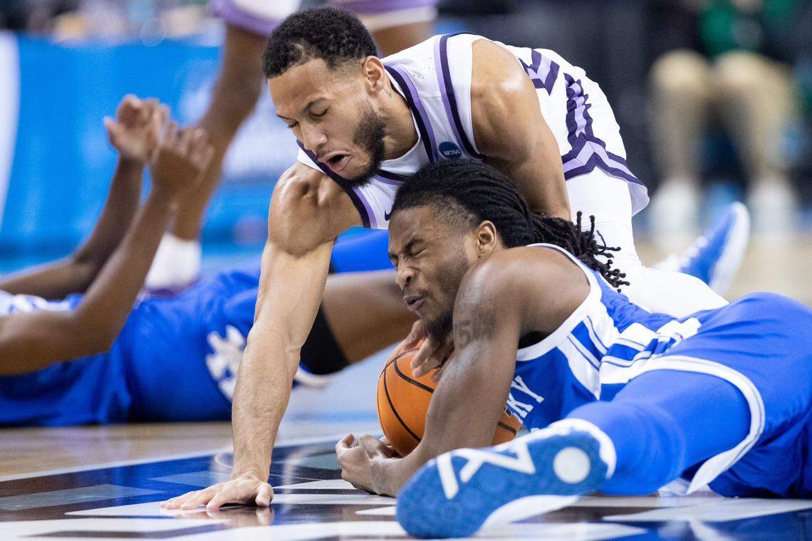 Kentucky’s Cason Wallace, bottom right, tries to track down the ball during the team’s second-round NCAA Tournament game against Kansas State on Sunday, March 19, 2023, in Greensboro, N.C.