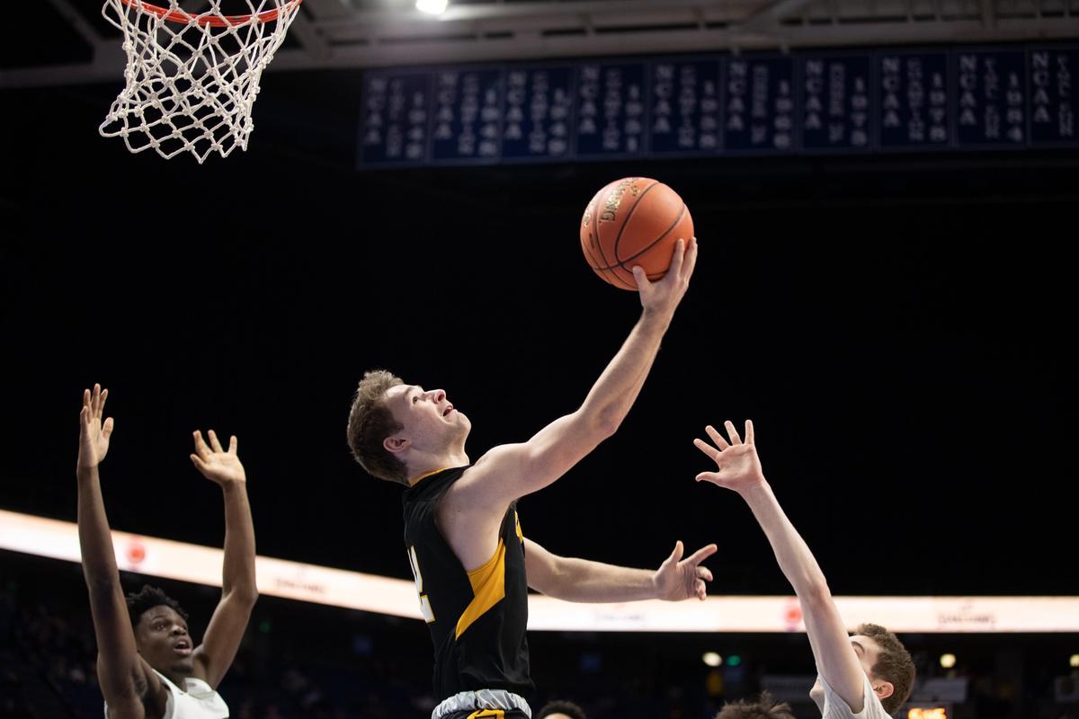 Johnson Central’s Cory VanHoose put up a shot against Trinity on Wednesday afternoon. VanHoose led the Golden Eagles with 14 points.