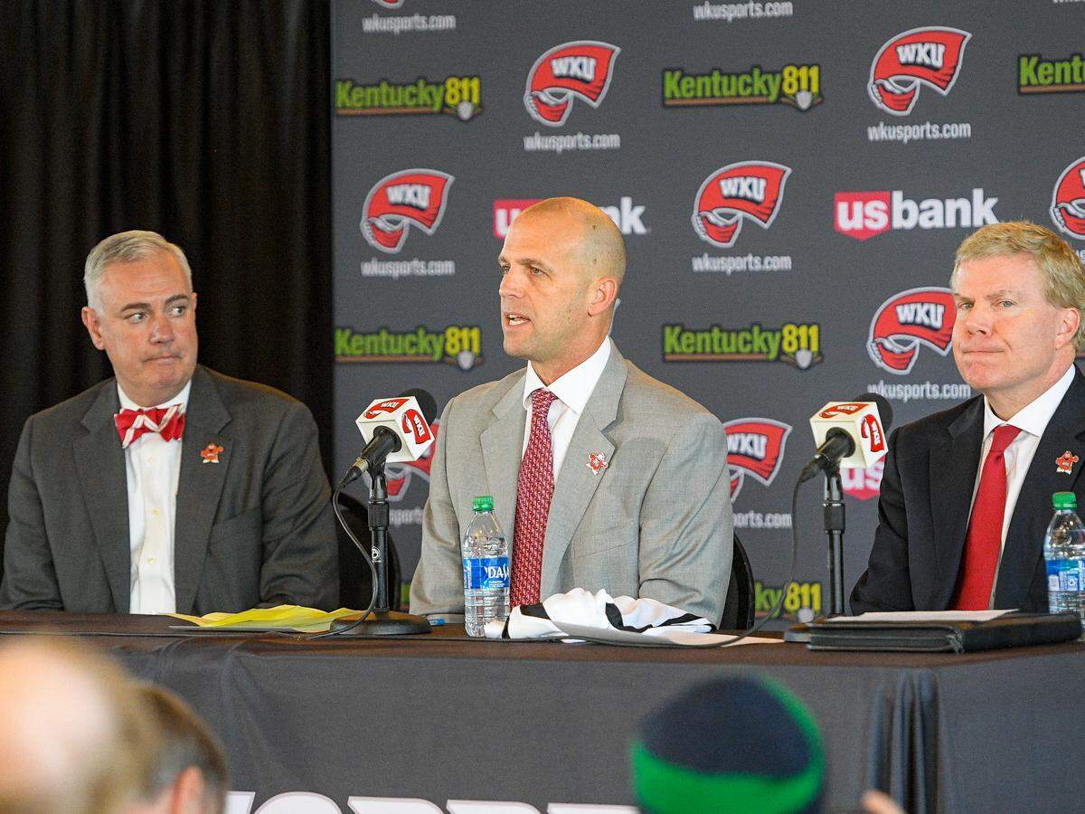 On the day he was introduced as the new Western Kentucky Hilltoppers men’s basketball coach, Steve Lutz (center) spoke at a news conference while flanked by WKU President Tim Caboni, left, and Athletics Director Todd Stewart, right. “Western has an expectation to go to the NCAA Tournament,” Lutz says. “Todd Stewart and Dr. Caboni absolutely voiced that in the interview process.”
