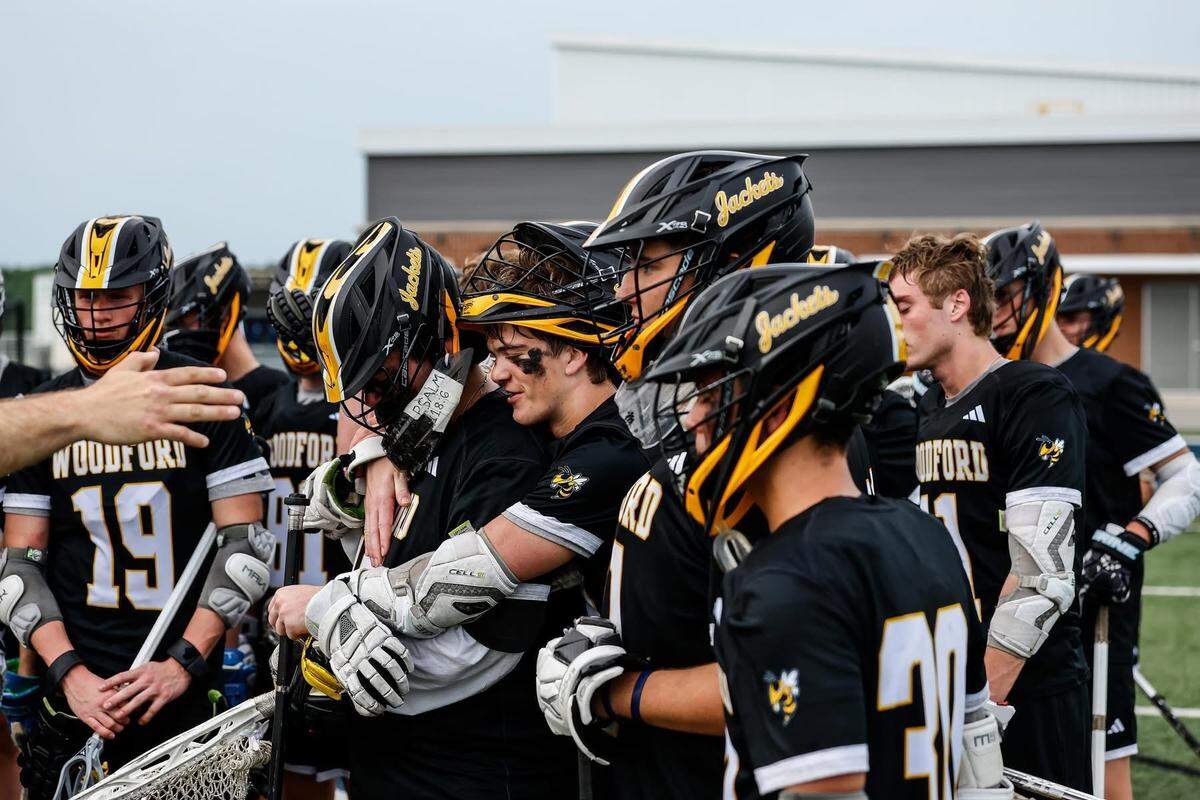 Woodford County’s boys lacrosse players gathered around their coaches following the Yellow Jackets’ 17-12 defeat to St. Xavier in the KHSAA Boys’ Lacrosse State Tournament semifinals on Monday at Great Crossing High School in Georgetown.