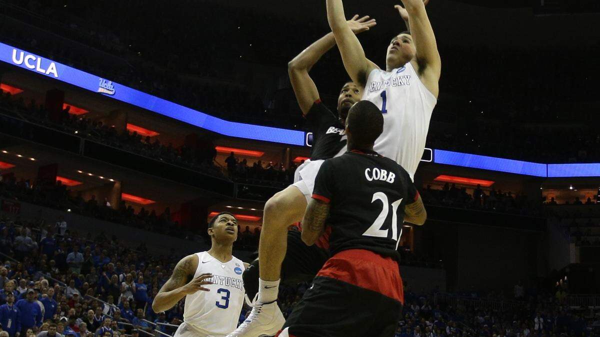 Kentucky guard Devin Booker put up a shot over Cincinnati guard Farad Cobb. Booker finished with six points.