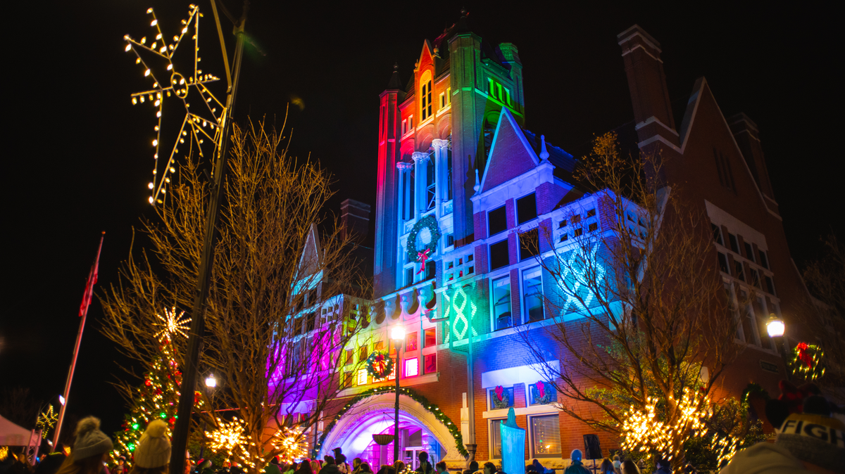 Crowds gather in Bardstown to observe a Christmas light display at the town’s courthouse. The building itself is light up in red, blue and green.