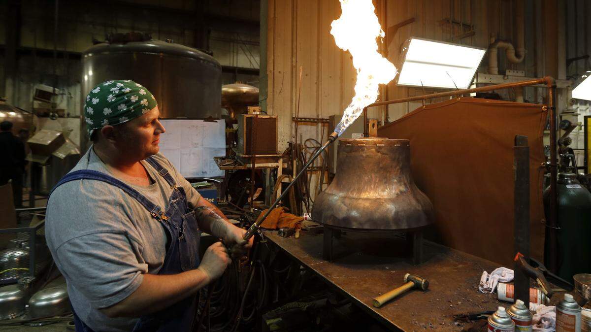 Vendome Copper and Brass Works in Louisville is one of the industry's biggest still makers. There is no showroom floor. Every still is custom designed and takes seven to nine months to make, including the polishing that Josh Smith did here. If you want a still, vice-president Mike Sherman said, "First, try to figure out what you want to make, then how much you want to make, then are you going to be in a tourist area?" A standard 250- to 1,000-gallon copper still costs $80,000 to $250,000. Extras and upgrades might bring the price to $600,000. A mirror finish alone adds 30 percent to the price.      