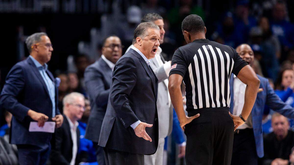 John Calipari talks with a referee during a game this season, with his assistant coaches, from left, Chuck Martin, John Welch, Chin Coleman, Orlando Antigua and Bruiser Flint in the background.