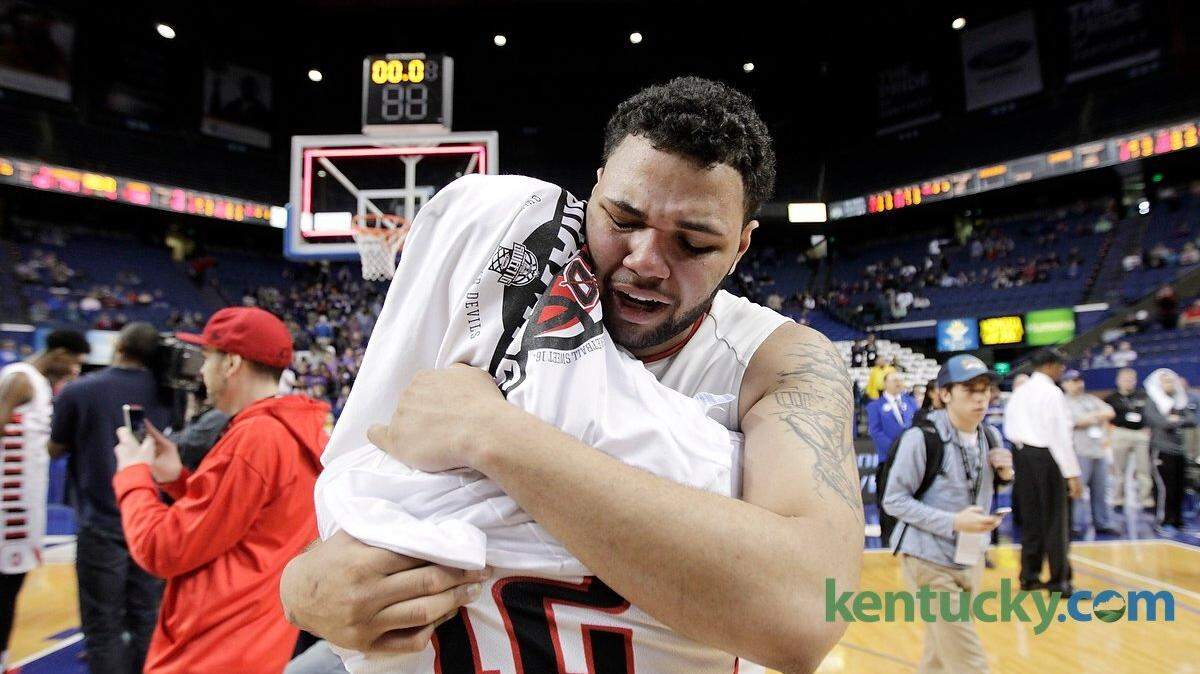 Owensboro MVP Justin Miller (55) hugged teammate Shawn Pendelton (12) after winning the Whitaker Bank/KHSAA Boys' Sweet 16 State Championship Game between Bowling Green and Owensboro at at Rupp Arena in Lexington, Ky., on March 22, 2015. Owensboro beat Bowling Green 74-58 to win the state championship.  Photo by Pablo Alcala | Staff