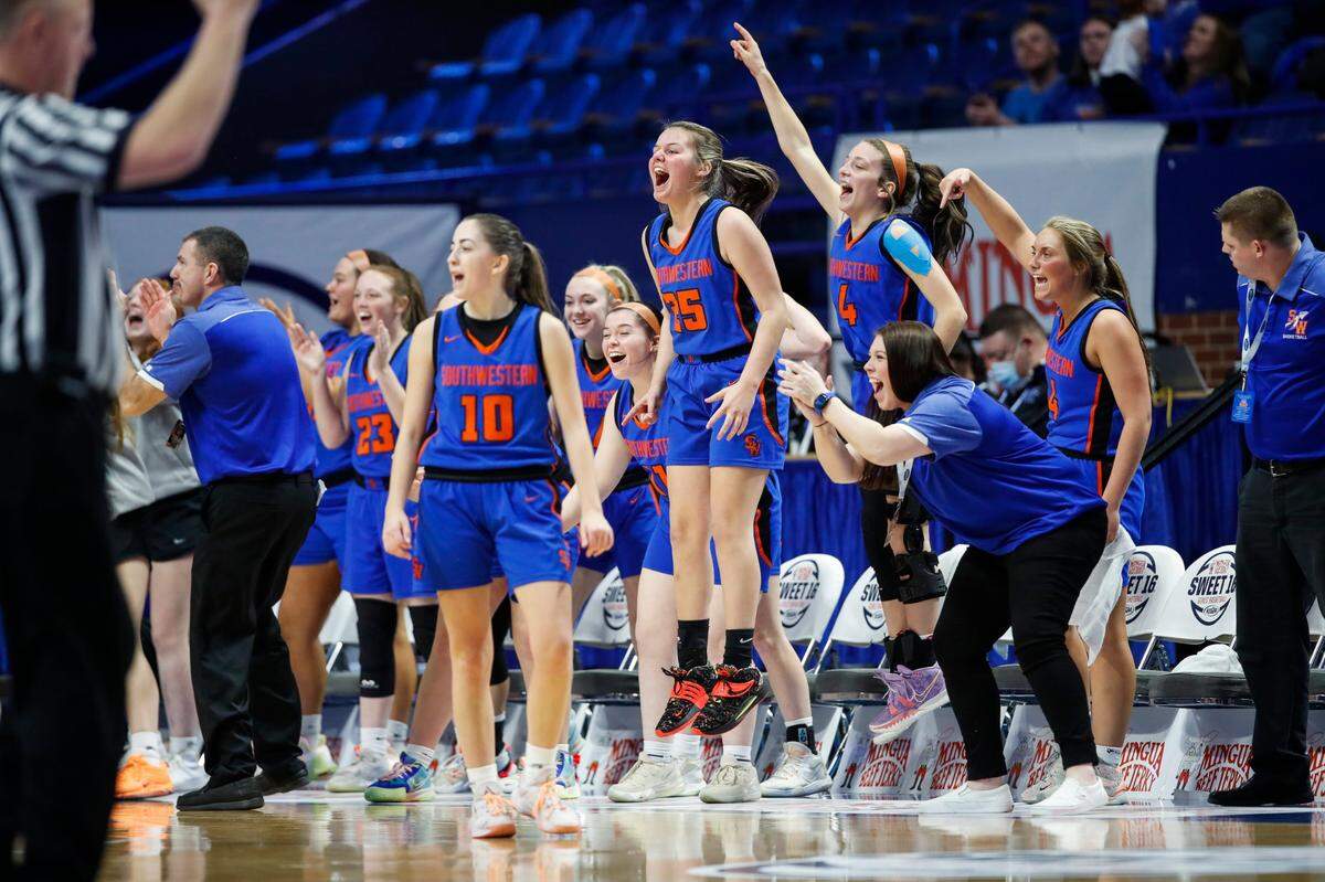 The Southwestern Warriors bench celebrates after their team scored against the McCracken County Lady Mustangs during the first round of the KHSAA Mingua Beef Jerky Girls’ Sweet 16 at Rupp Arena on March 9.