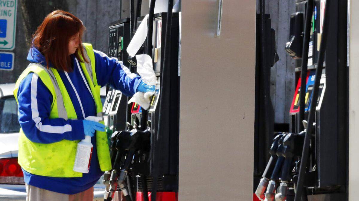 FILE - In this March 31, 2020 file photo, a worker cleans and sanitizes a pump at the Speedway gas station in Concord, N.H.
