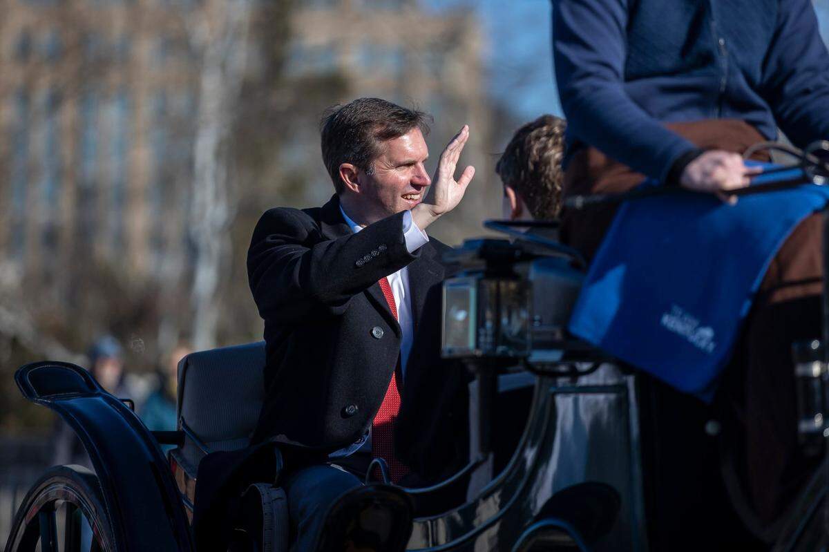 Kentucky Gov. Andy Beshear waves to people during the Inaugural Parade along Capital Avenue in Frankfort, Ky., on Tuesday, Dec. 12, 2023.