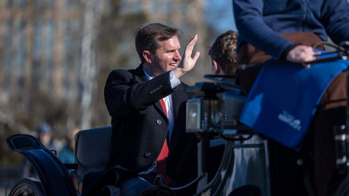 Kentucky Gov. Andy Beshear waves to people during the Inaugural Parade along Capital Avenue in Frankfort, Ky., on Tuesday, Dec. 12, 2023.