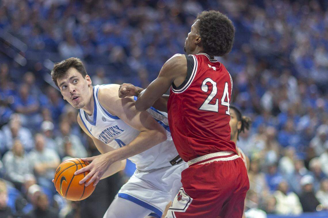 Kentucky forward Andrija Jelavic (4) looks to move the ball as Nicholls guard Zee Hamoda (24) defends during Tuesday’s game at Rupp Arena. 