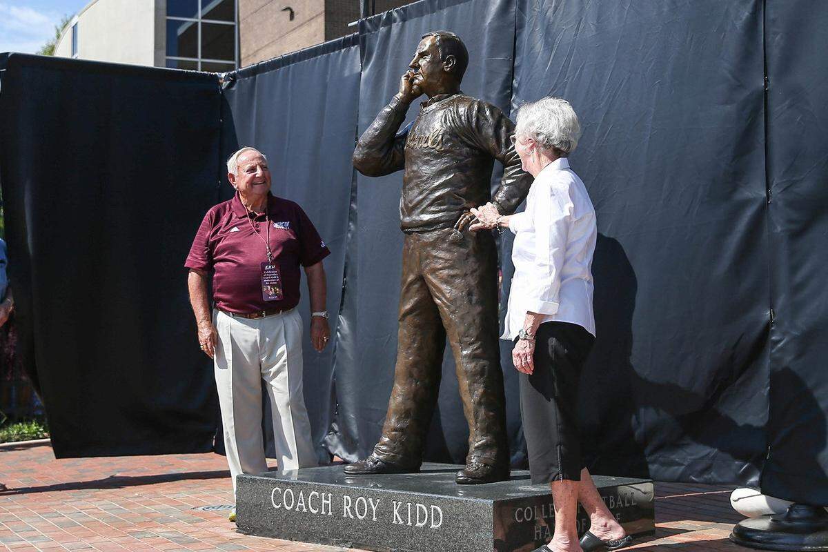 Roy Kidd, left and his wife, Sue, examined the larger-than-life statue of the former Eastern Kentucky University football coach that was unveiled at EKU in 2017.