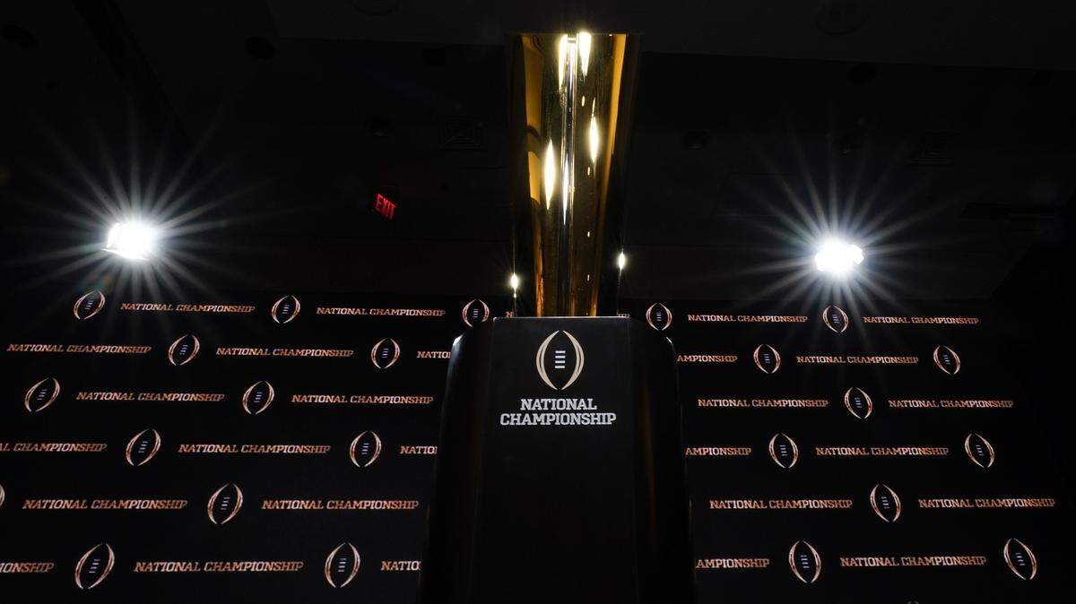 The trophy is displayed before a news conference for the NCAA College Football Playoff national championship game Sunday, Jan. 12, 2020, in New Orleans. Clemson is scheduled to play LSU on Monday. (AP Photo/David J. Phillip).