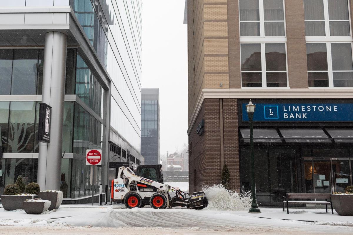 Sidewalks are cleared of snow and ice slush by a street sweeper in Lexington, Ky., Monday, February 15, 2020. Lexington is currently under a ice storm warning according to the National Weather Service.