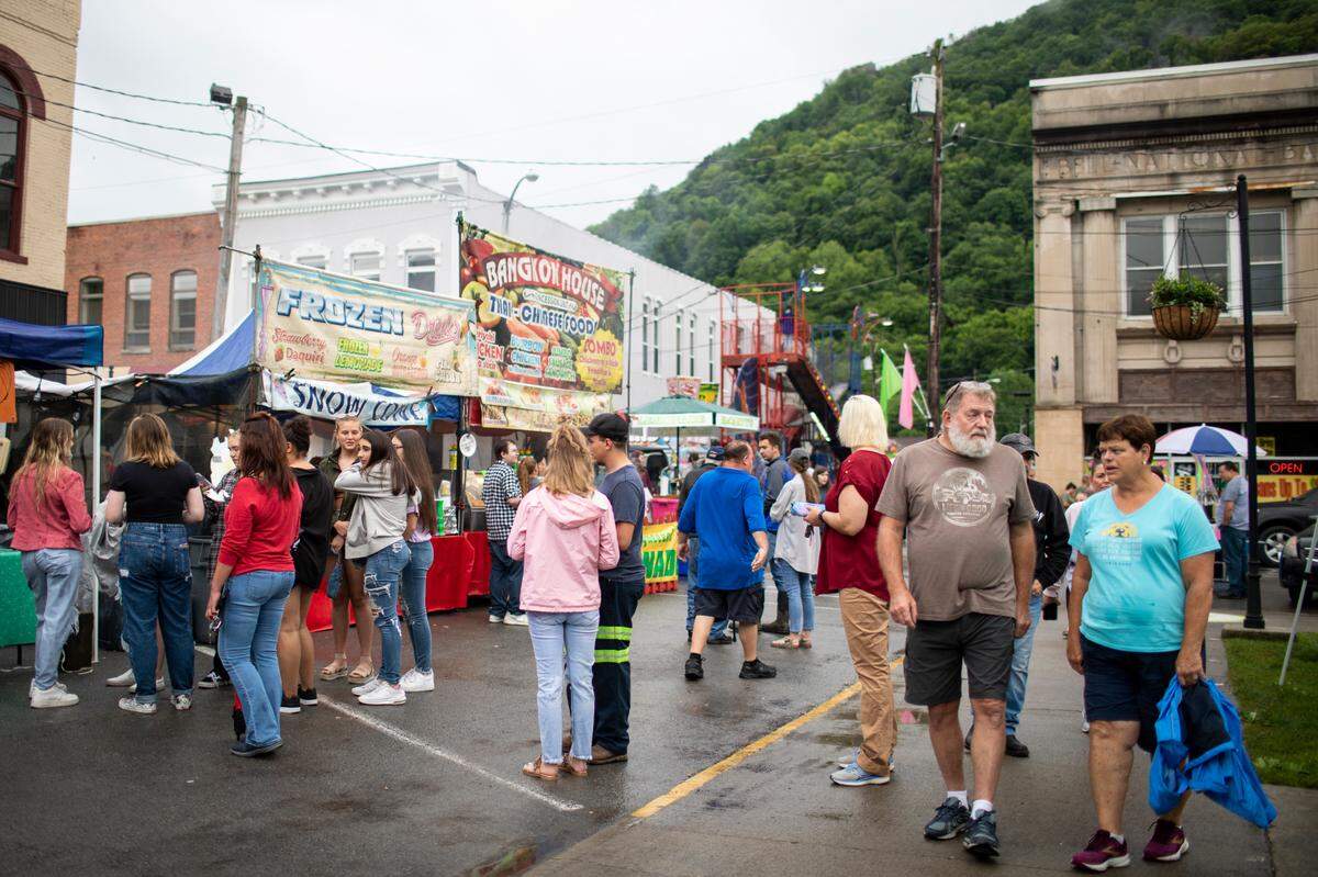 People line up for carnival rides, tents selling food, treats and merchandise Friday in downtown Pineville during the Kentucky Mountain Laurel Festival. The popular four-day event drew thousands.