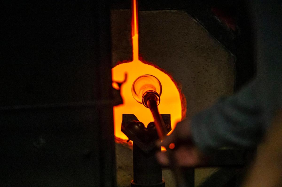 Patrick Martin, Centre College professor of art, demonstrates how to work with hot glass at the glassblowing studio in the Jones Visual Arts Center at Centre College in Danville, Ky., on Monday, Nov. 28, 2022. Martin studied under Stephen Rolfe Powell when Martin was a student at Centre.