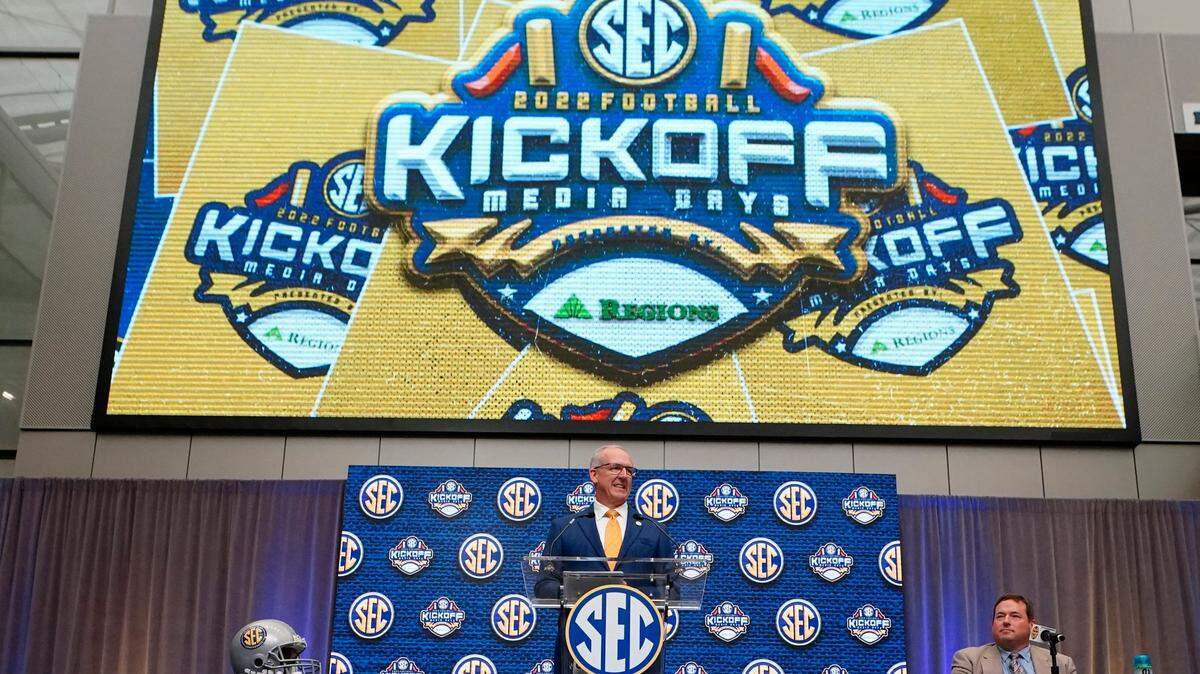 Southeastern Conference commissioner Greg Sankey speaks during SEC Media Days, Monday, July 18, 2022, in Atlanta. Person at right is unidentified. (AP Photo/John Bazemore)