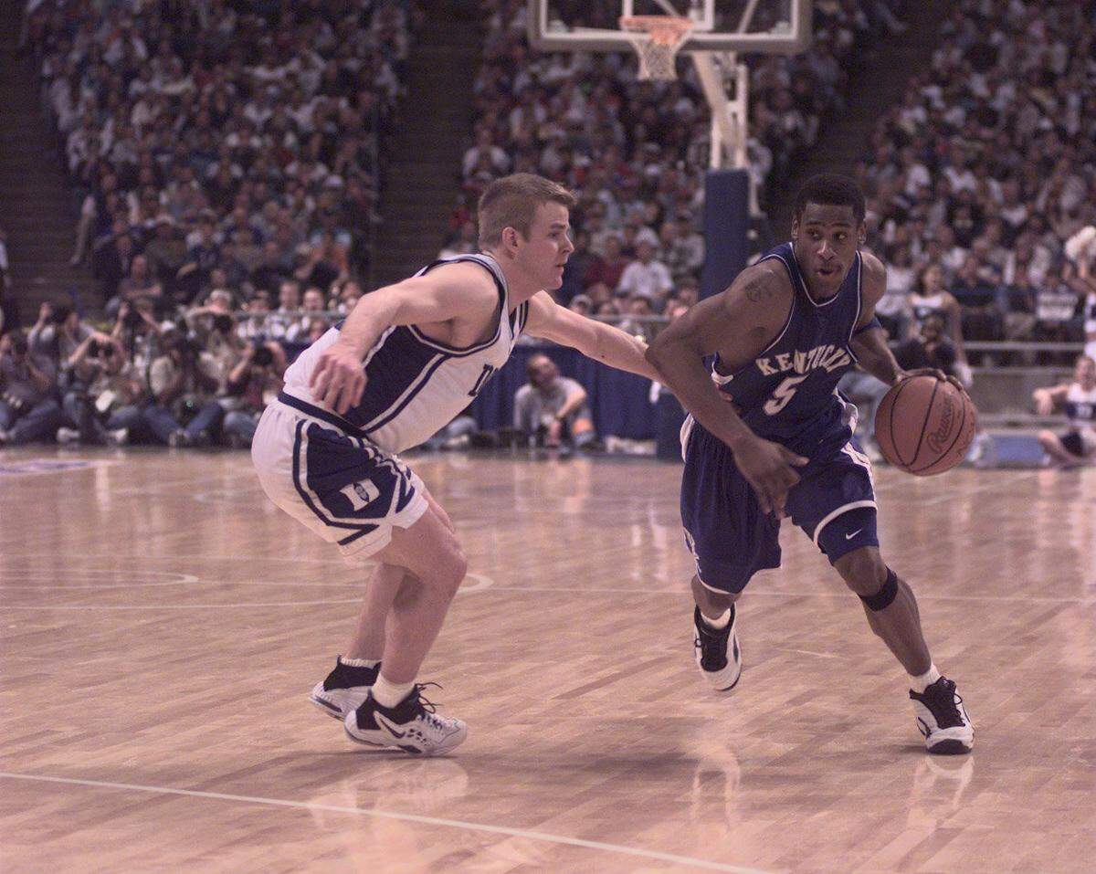 Kentucky’s Wayne Turner launched a major UK comeback that carried the Wildcats from 17 down to an 86-84 win over Duke in the 1998 NCAA Tournament South Region finals with his success driving the ball against the Blue Devils’ Steve Wojciechowski.