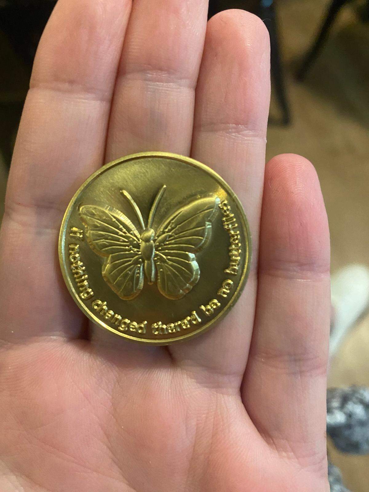Megan received a coin as a part of graduation: a butterfly on the front with “If nothing changed there’d be no butterflies.”