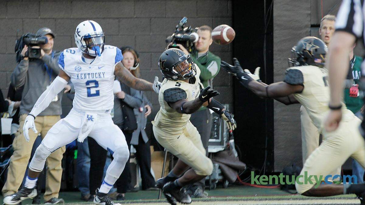 A pass intended for Kentucky wide receiver Dorian Baker (2) was intercepted by Vanderbilt safety Oren Burks (20) with help from Vanderbilt cornerback Torren McGaster (5) in th second quarter of the Kentucky at Vanderbilt football game at Vanderbilt Stadium in Nashville, Tenn.,, on Nov. 14, 2015. Photo by Pablo Alcala | Staff