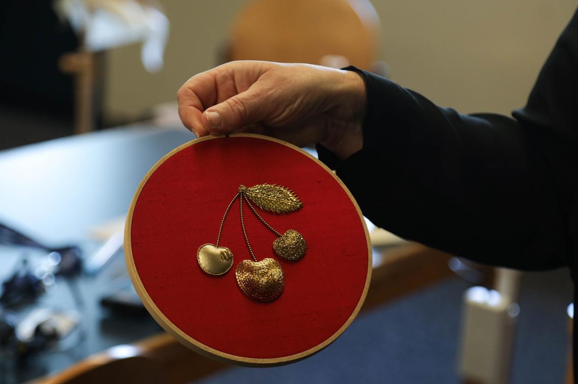 Dr. Susan Kay-Williams displays an example of what students strive for while attending the Royal School of Needlework classes.