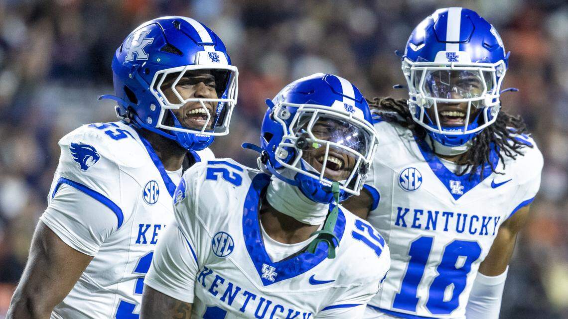 Kentucky linebacker Alex Afari Jr. (3), defensive back Quay'Sheed Scott (12) and defensive back Cam Dooley (18) celebrate a second-half stop during UK’s 10-3 win against Auburn on Saturday.