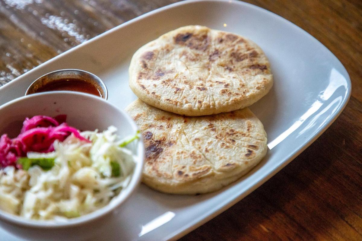Pupusas – corn-based patties stuffed with either soft Honduran cheese or chorizo and and quesillo – are served with salsa pueblo and two types of “encurtidos” on the side: cabbage and cilantro and pickle onions at Mami Monchitas in Frankfort, Ky.