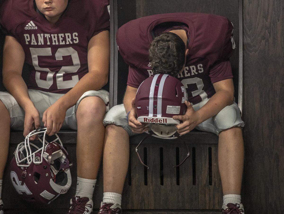 Jackson Wilkerson, left, and Gaige Conn, sit in Pikeville’s locker room moments before taking the field.
