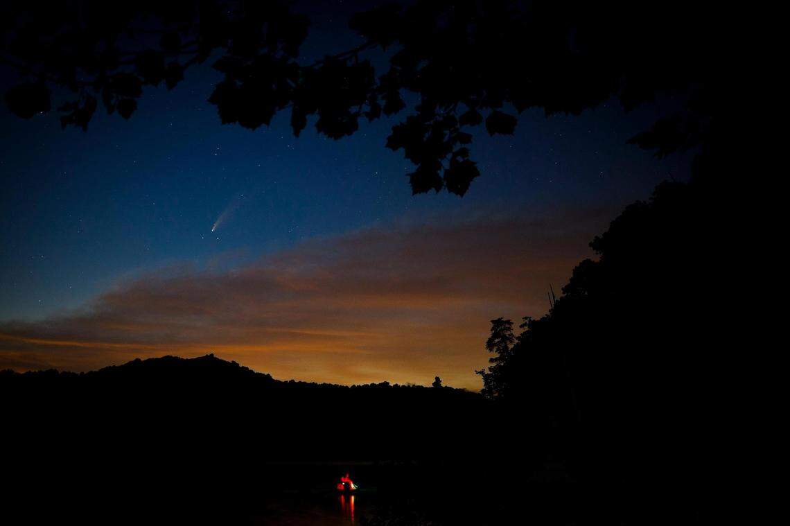 the comet Neowise, or C/2020 F3, is seen over fishermen on Cave Run Lake in Rowan County, Ky., Saturday, July 18, 2020.