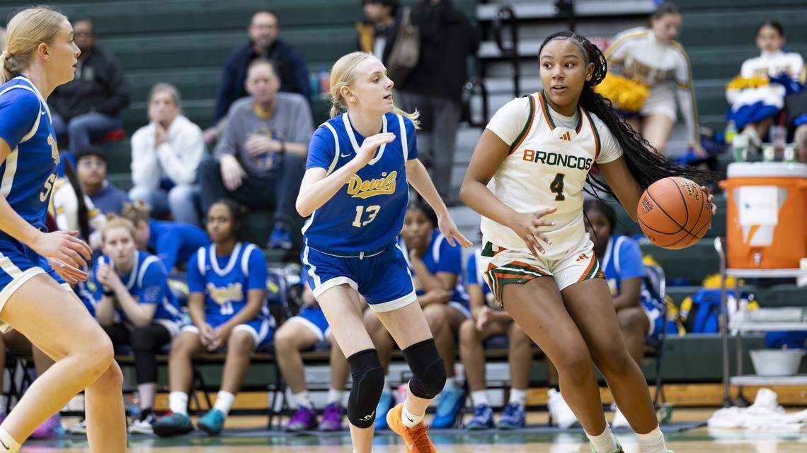 Frederick Douglass guard Tamia Waide (4) dribbles down the baseline against Henry Clay’s Nora Jane Dick during the Broncos’ 79-50 win in the 42nd District girls basketball semifinals at Bryan Station High School on Tuesday.