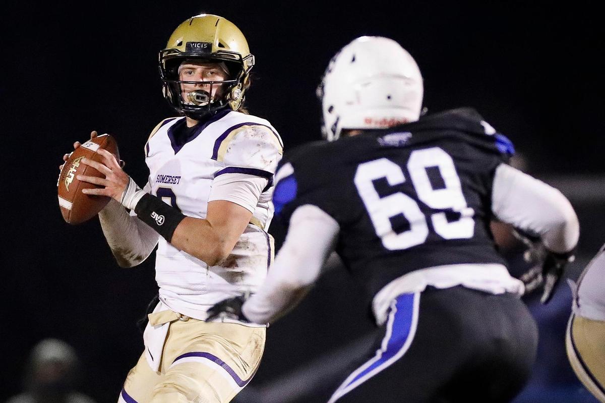 Somerset’s Kaiya Sheron, left, looked to pass the ball while Lexington Christian’s Anthony Johns (69) pursued during the Class 2A playoffs on Nov. 27.