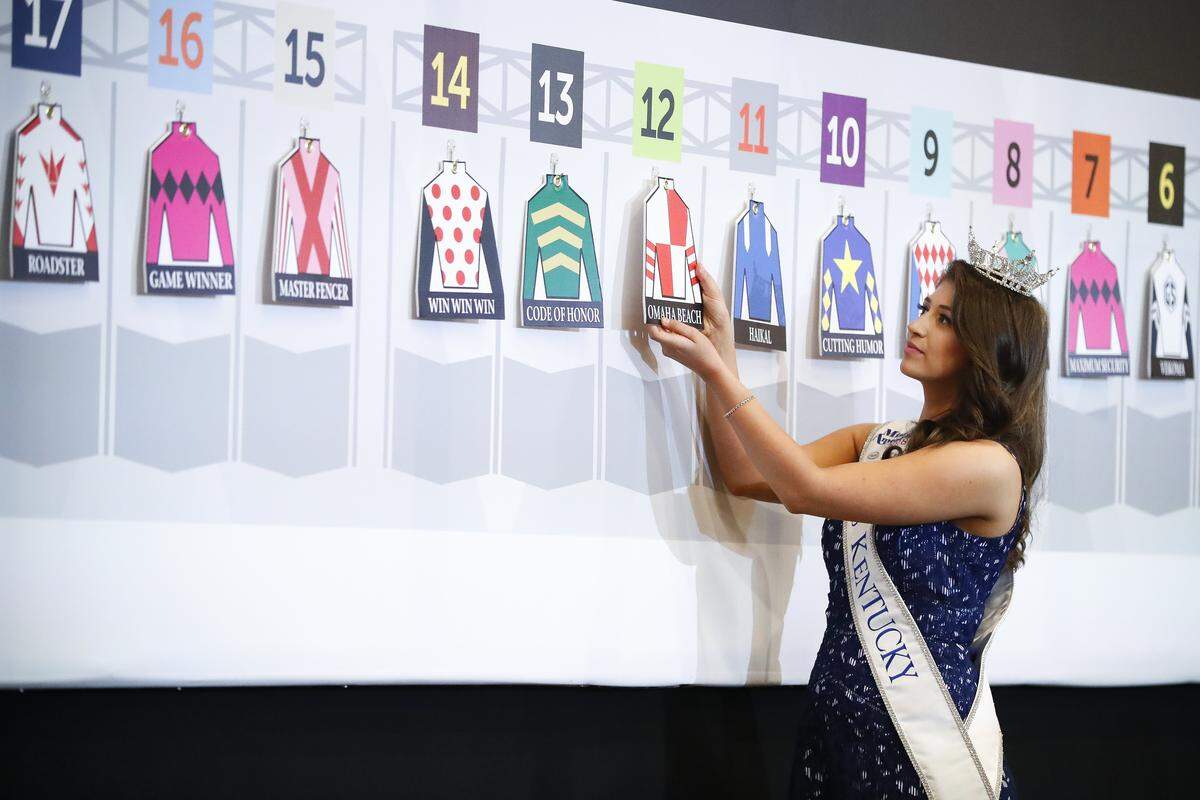 Miss Kentucky Katie Bouchard placed a placard representing Kentucky Derby favorite Omaha Beach during Tuesday’s post-position draw.