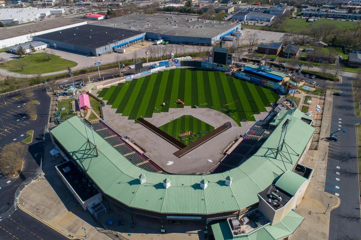 Workers install a turf field at the recently renamed Wild Health Field in Lexington, Ky., on Sunday, April 10, 2022. The stadium will be the home stadium for both of Lexington’s teams in the Atlantic League of Professional Baseball – the Lexington Legends and Kentucky Wild Health Genomes. In addition to the turf, the ballpark has undergone several enhancements this offseason: new video board, new LED signage boards and new signs for it being Wild Health Field.