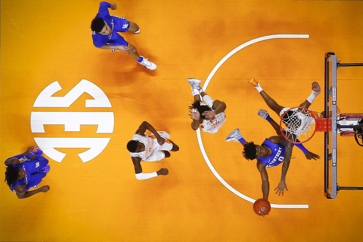 Kentucky Wildcats guard Ashton Hagans scores past Tennessee Volunteers guard Jordan Bowden during their game at Thompson-Boling Arena in Knoxville, Tenn., Saturday, Feb. 8, 2020. Kentucky beat Tennessee 77-64.