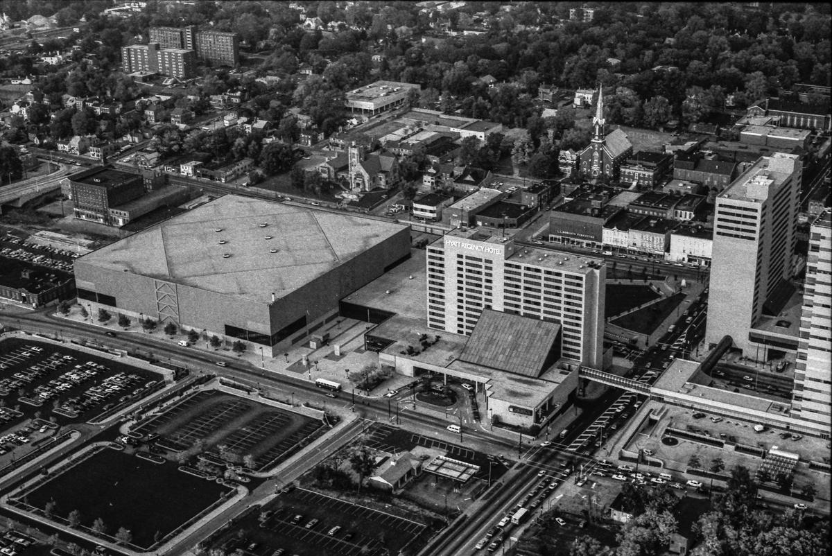 An aerial view of Rupp Arena and downtown Lexington, Oct. 4, 1982. At the center is the 17-story Hyatt Regency Hotel, which opened in 1977. To its left is the Lexington Center and iconic Rupp Arena. The grand opening of Rupp was Oct. 7 to 10, 1976 and the first concert there featured Lawrence Welk and his orchestra. When it opened, Lexington Center was a five-fold operation: the convention-exposition hall, Rupp Arena, a shopping mall, the 366-room Hyatt, and the Lexington Opera House. Behind the Hyatt is Triangle Park, which officially opened just three months earlier before an estimated 4,000 people who oohed and aahed as the lights and fountains came on. Across Main Street are businesses and buildings, including the longtime H.H. Leet Furniture Co., that would become Victorian Square in 1985. Across West High Street from the Hyatt is a Speedway gas station.
