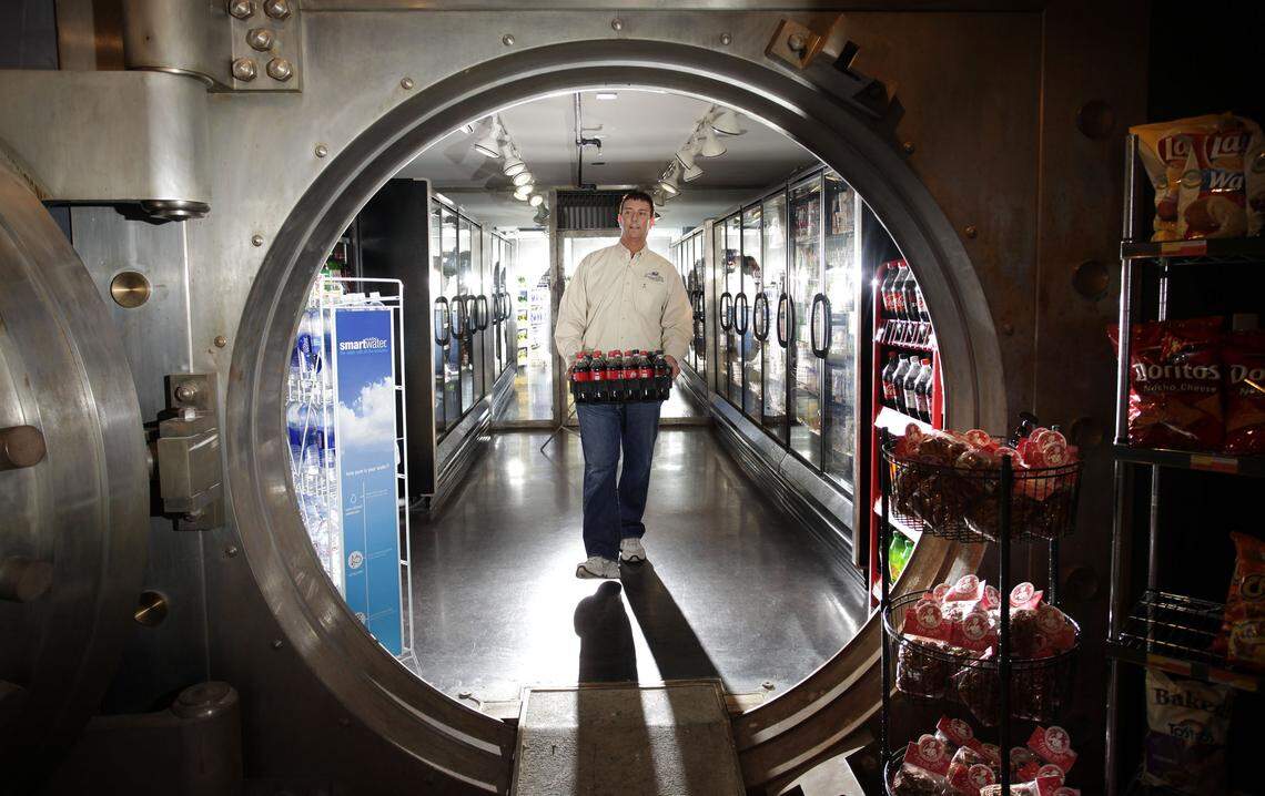 Manager Rusty Campbell brought stock out of a vault that doubles as a storage room at Shorty’s, The Urban Market, located in a former bank.